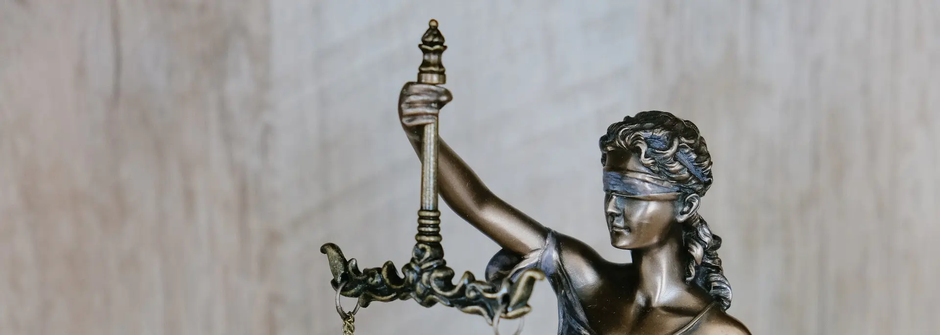 woman holding sword statue during daytime